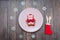 Cute Pig Cookie Gingerbread Symbol of Year on plate and snowflakes on wood background. Christmas
