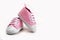Cute pink baby girl sneakers close up on gray