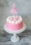 Cute pink cream cake with a princess topper decoration