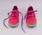 Cute pink kids shoes with purple laces , front view