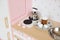 Cute pink kitchen for kids. Cake and eggs on play table and kettle on stove