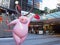 Cute pink pig sculpture with funny posture to celebrate year of the pig at World square building.