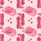 Cute pink seamless pattern with retro cowgirl hats and cowboy boots. Background, print for girls.