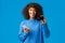 Cute pleased african-american female bank customer recommend credit card and banking system service, holding smartphone