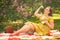 Cute plus size caucasian girl wearing a cute vintage yellow dress and enjoying a vacation in the summer Park on the green grass. c