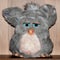 Cute plush toy. A small animal with big blue eyes