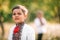 Cute portrait of little ukrainian boy in spring garden. Child in traditional embroidery vyshyvanka shirt. Ukraine