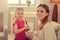 Cute positive mother and daughter putting on makeup together