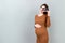 Cute Pregnant Lady Posing With Baby Sonography Photo Near Colored background. Concept of pregnancy, gynecology, medical