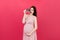 Cute Pregnant Lady Posing With Baby Sonography Photo Near Colored background. Concept of pregnancy, gynecology, medical