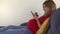 Cute pregnant woman browse photos and internet with smart phone