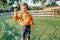 Cute preschool Caucasian child boy blowing soap bubbles in park at summer sunset