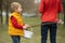 Cute preschool child, whipping his sister on Easter with twig, braided whip made from pussy willow, traditional symbol of Czech