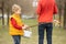 Cute preschool child, whipping his sister on Easter with twig, braided whip made from pussy willow, traditional symbol of Czech