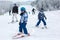 Cute preschool children, skiing in Austrian winter resort on a c