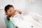 Cute preschool girl practicing good hygiene using the bathroom sink as she washes up