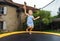 Cute preschooler girl jumping on trampoline