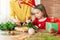 Cute preschooler girl wearing reindeer antlers and her mother making christmas wreath in living room. Christmas family time fun.