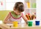 Cute preschooler kid girl drawing with pencils at home