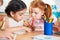 Cute preschoolers drawing with colorful pencils