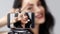 Cute Pretty Girl With Bright Makeup Showing Peace Gesture While Taking Selfie on Mobile Phone. Woman Beauty Vlogger