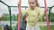 Cute pretty Preschool children in swing on playground. Little girl in skirt laughing and having fun, swinging on seesaw