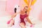 Cute pretty woman in tight glitter summer dresswith inflatable flamingo in swimming pool with foam plastic balls