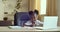 Cute primary school age girl of mixed race ethnicity studying alone drawing on paper. African daughter doing homework