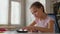 Cute primary school girl doing homework lesson, counting on calculator