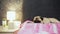 Cute pug dog falls asleep on bed in bedroom