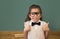 Cute pupil dressed up as teacher in classroom