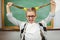 Cute pupil pulling her hair in a classroom