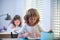 Cute pupil writing at desk in classroom at the elementary school. Student boy doing test in primary school. Children