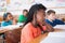 Cute pupils listening attentively in classroom