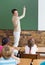 Cute pupils listening to their teacher in classroom