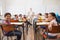 Cute pupils smiling at camera in classroom