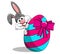 Cute rabbit or bunny peek a boo behind painted egg with bow isolated