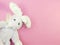 Cute rabbit doll on pink polka dot background