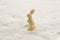 A cute rabbit shaped chocolate in the white snow as an abstract still life