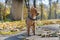 Cute red haired chihuahua with black leash for a walk in the autumn park.