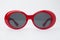 Cute red round sunglasses on white background