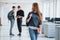 Cute redhaired girl. Group of young people walking in the office at their break time