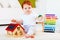 Cute redhead baby playing with wooden toys, numerals, learning to count