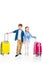 cute redhead children holding hands while standing with suitcases