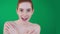 Cute redhead woman playing on camera with naked shoulders.
