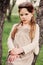 Cute romantic child girl in beige natural dress