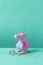 Cute rubber dragon toy on green background