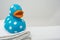 Cute Rubber Duck on a White Towel in Bathroom Close Up