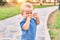 Cute and sad little boy crying having a tantrum at the park on a sunny day