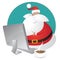 Cute Santa shopping for christmas on his computer